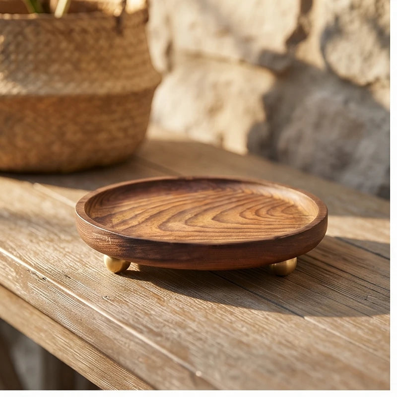 Brass ball A wooden tray styled in a warm home setting