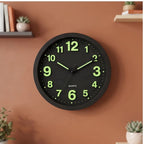 Black clock styled in a warm home setting