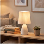 White ceramic lamp styled in a warm home setting