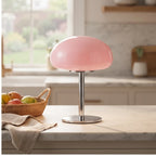 Pink glass lamp styled in a warm home setting - 2