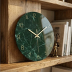 Green marble tempered glass wall clock with gold hands, modern style.