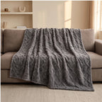 Gray fleece throw styled in a warm home setting - 2
