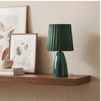Green ceramic lamp styled in a warm home setting - 2