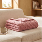 Pink fleece blanket styled in a warm home setting