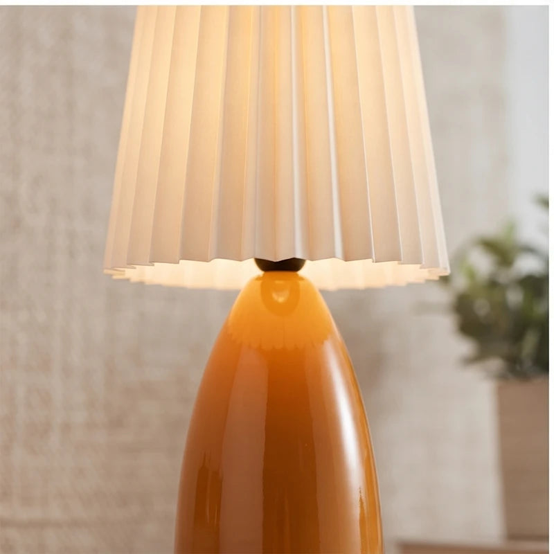 Orange ceramic lamp styled in a warm home setting - 2