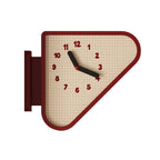 A triangular wall clock with a red border, beige grid-patterned face, black hands, and red numerals, shown against a plain white background.