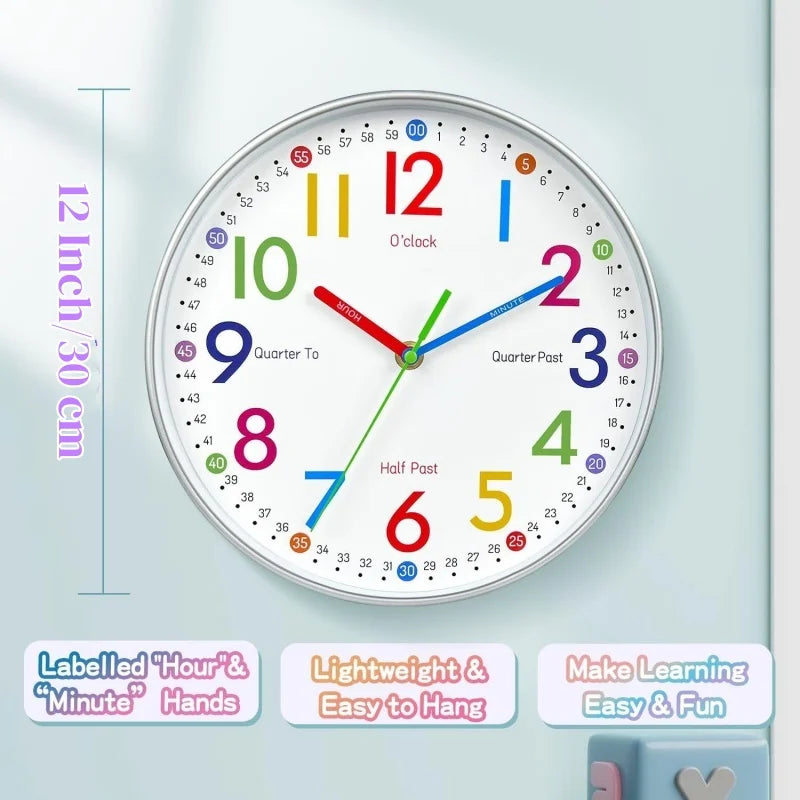 A round children's wall clock with colorful numbers and multicolored hands on a pale blue background. Purple text on the left reads '12 inch / 30 cm', and three feature callouts appear along the bottom.