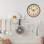 Round wood-grain wall clock with black frame and black hands.