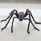 A large realistic fake spider toy with long dark hairy legs and small red eyes, placed on a light gray tiled floor.