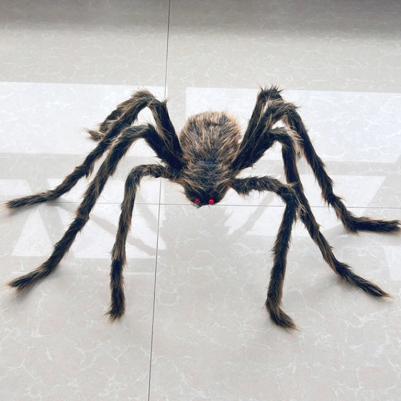 A large realistic fake spider toy with long dark hairy legs and small red eyes, placed on a light gray tiled floor.