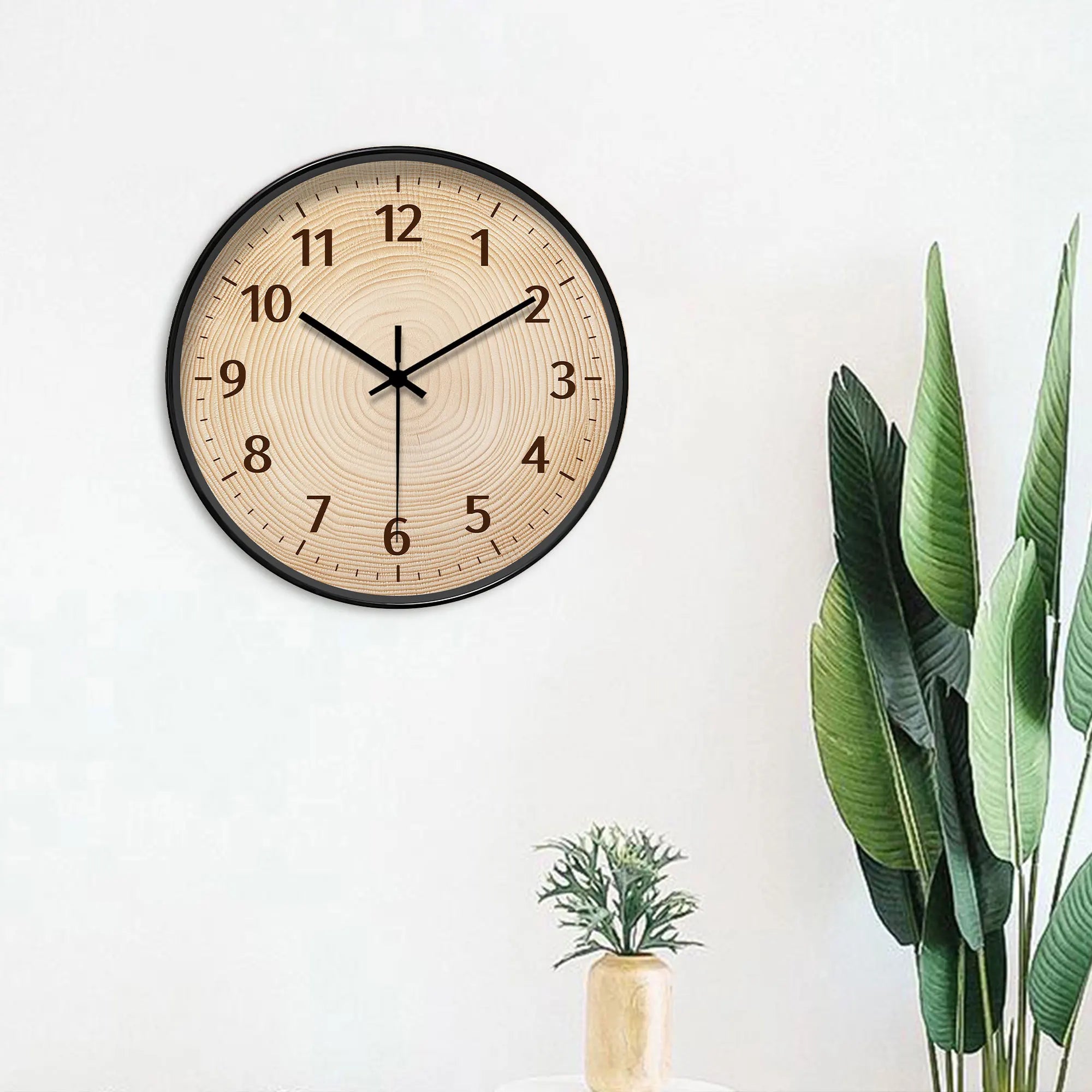 Round wood-grain wall clock with black frame and dark numerals.