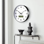 Black metal wall clock with a digital calendar display.