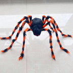 A large Halloween toy spider with a black body and bright orange and black striped legs, positioned on a light gray tiled floor.
