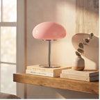Pink glass lamp styled in a warm home setting