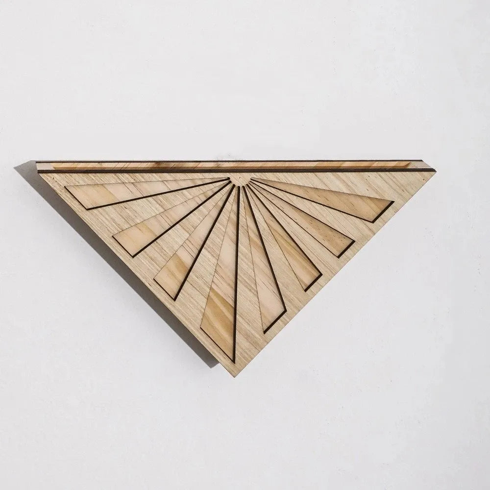 Light wood triangular wall decor with a carved fan pattern and dark outlines, against a white background.