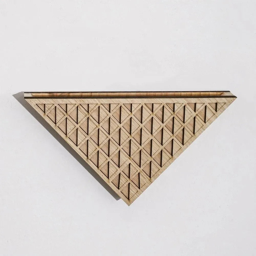 Light brown wooden triangular wall planter with a geometric diamond pattern carved into its front face, against a white background.