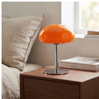 Orange glass lamp styled in a warm home setting - 4