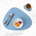 Light blue faux leather oval placemat and coaster set.
