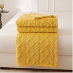 Yellow fleece blanket styled in a warm home setting