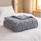 Blue fleece blanket styled in a warm home setting