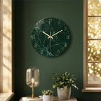 Round dark green marble glass wall clock with gold hands.