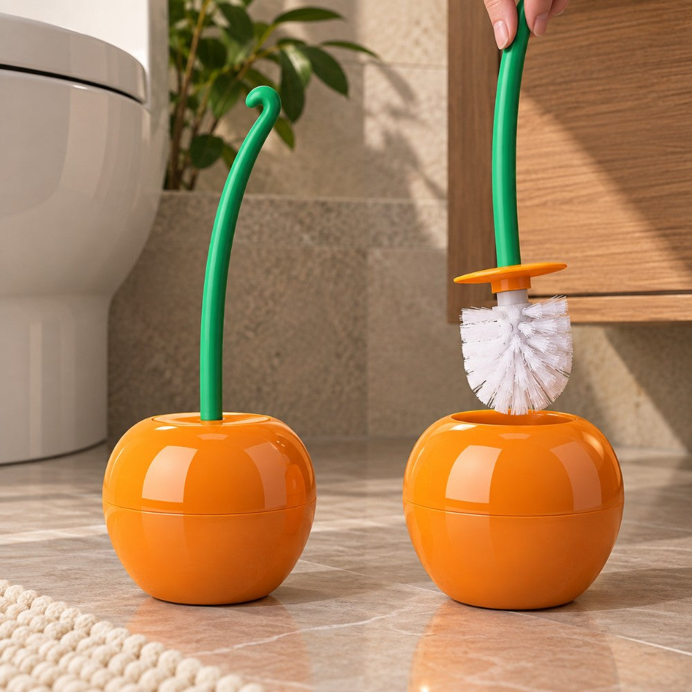 A hand pulls a green-handled toilet brush with white bristles from a bright orange spherical holder on a tiled floor.