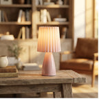 Pink ceramic lamp styled in a warm home setting