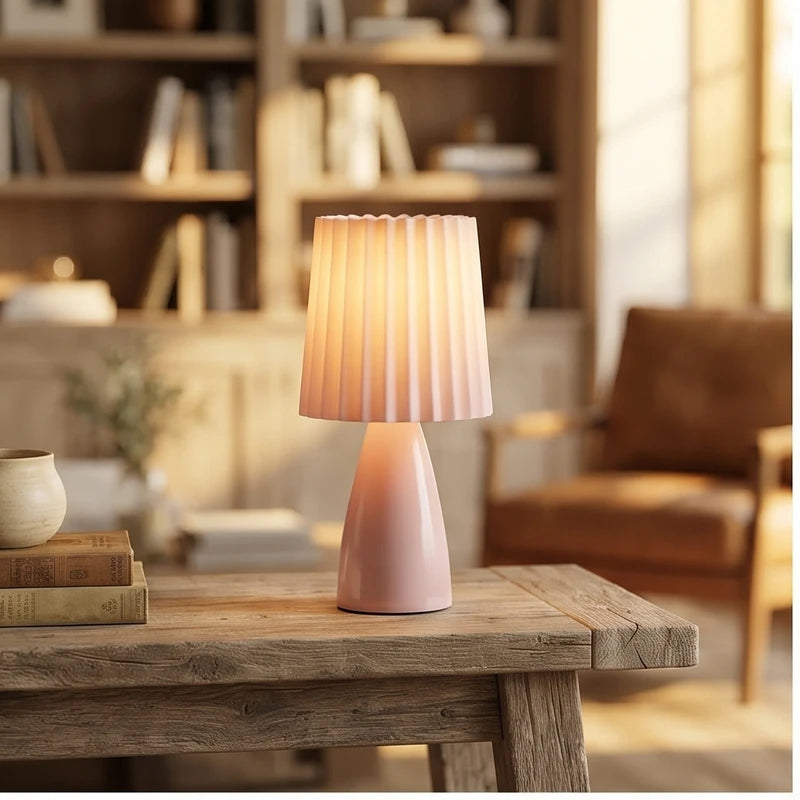 Pink ceramic lamp styled in a warm home setting