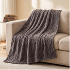 Gray fleece blanket styled in a warm home setting