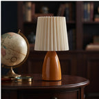 Orange ceramic lamp styled in a warm home setting - 3