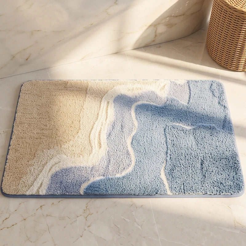 Rectangular textured rug featuring a beige, white, and blue wavy pattern, lying on a light marble floor.